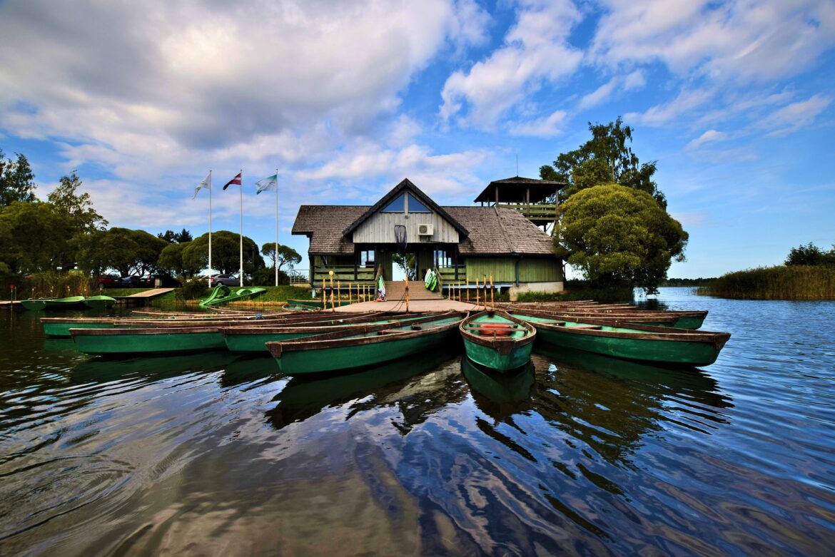 Latvia's National Parks: Rowboats on the calm waters of Lake Rāzna near a picturesque boathouse.