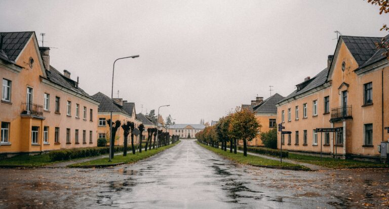 Soviet-era building in Seda, Latvia, with pastel colors and classical architecture under a cloudy sky