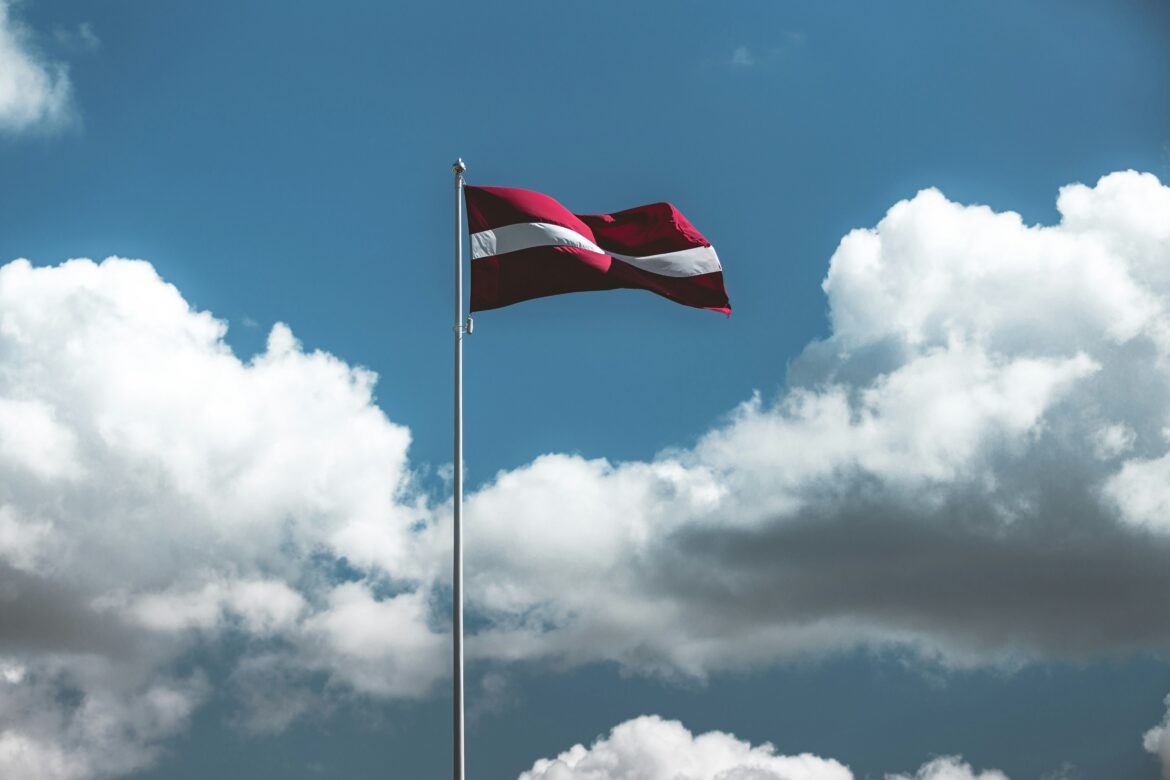 Latvian flag waving proudly, symbolizing the official language of Latvia and its rich culture
